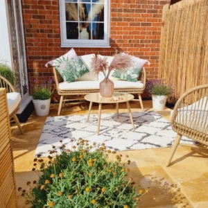 Garden seating area with rug and flowers